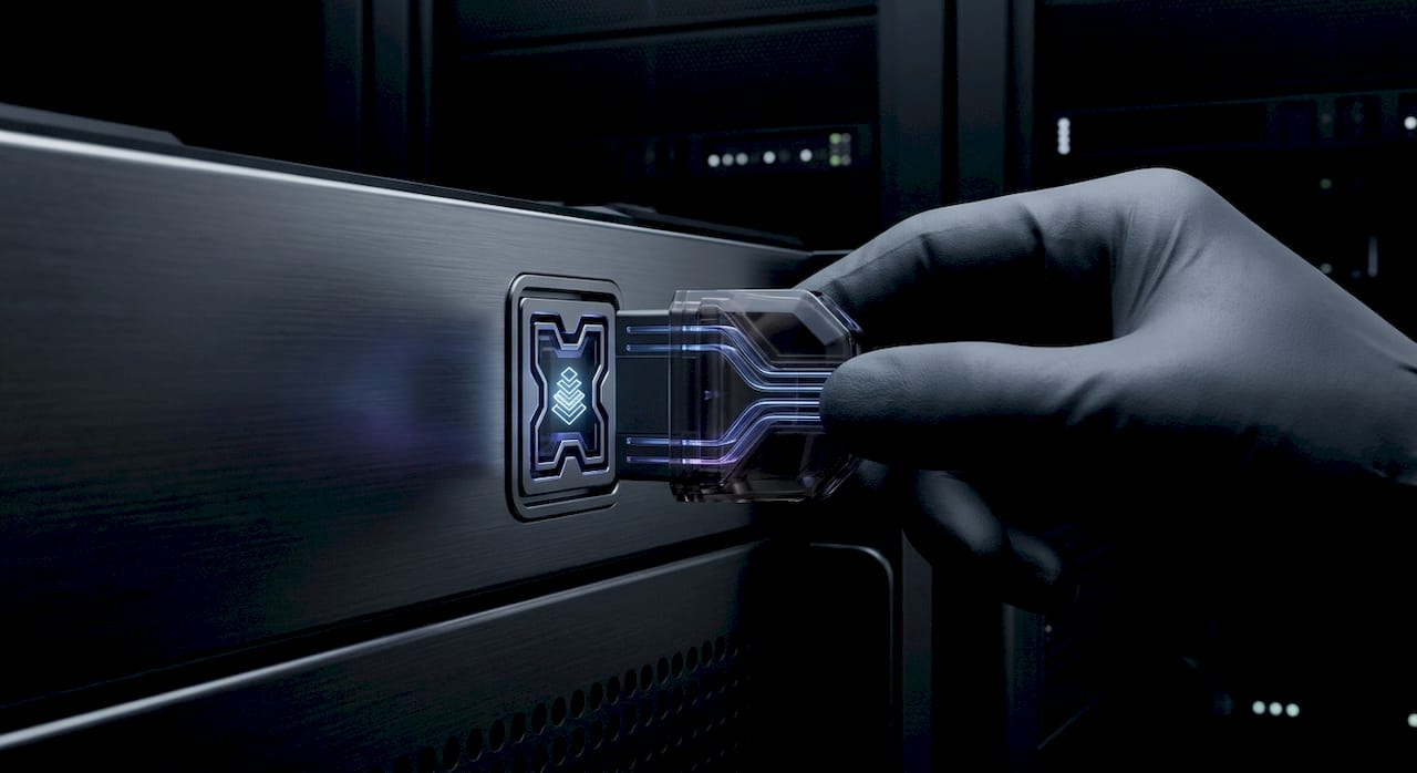 Gloved hand connecting an illuminated module into a server rack in a data centre